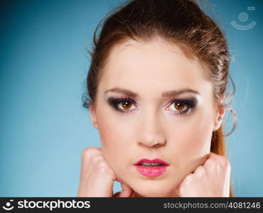 Young woman teen girl portrait on blue background