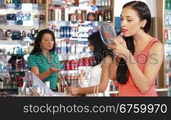 Young Woman Testing Lipstick in Beauty Department