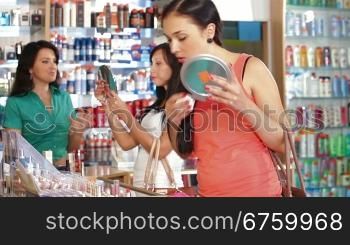 Young Woman Testing Lipstick in Cosmetics Store