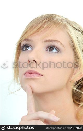 Young woman thinking with her finger to her chin
