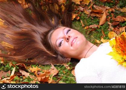 Young woman to lie autumn leaves hand fall yellow maple girl garden background