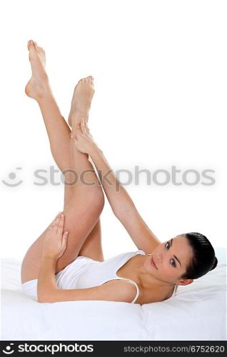 Young woman touching her smooth legs