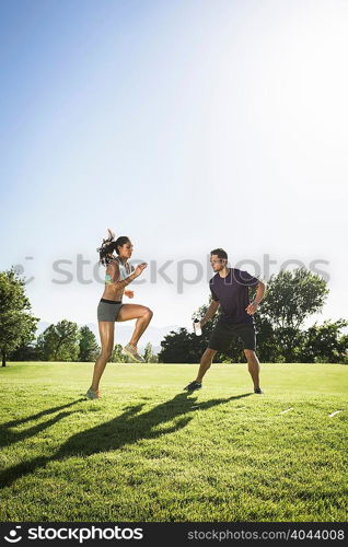 Young woman training with agility ladder in park