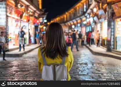 Young woman traveler walking at lijiang old town in China, Travel lifestyle concept