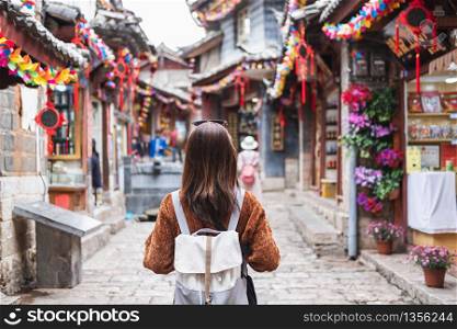 Young woman traveler walking at lijiang old town in China, Travel lifestyle concept
