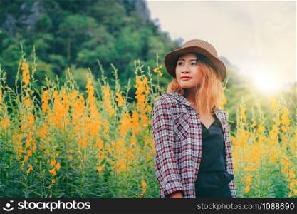 Young woman traveler walking in nature trail landscape. Travel and leisure concept.