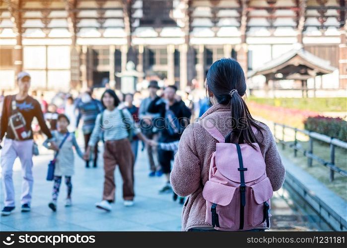 Young Woman traveling at Todaiji temple, Happy Asian traveler visit in Nara near Osaka. landmark and popular for tourists attractions in Nara, Japan. Asia travel concept