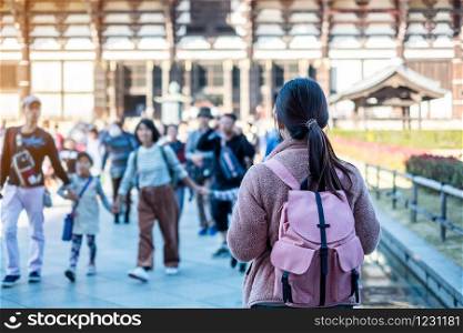 Young Woman traveling at Todaiji temple, Happy Asian traveler visit in Nara near Osaka. landmark and popular for tourists attractions in Nara, Japan. Asia travel concept