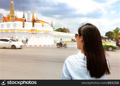 Young Woman traveling to Grand palace and Wat phra keaw at sunset at Bangkok, Thailand