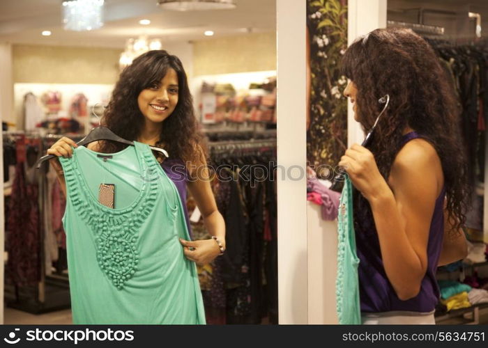 Young woman trying on dress at store