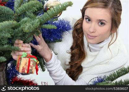Young woman under a Christmas tree