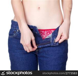 young woman unzipping jeans