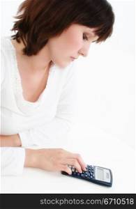 Young woman using a calculator