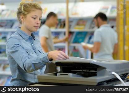 young woman using a copy machine
