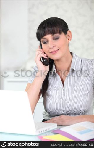 Young woman using a cordless phone