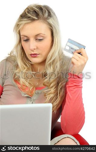 Young woman using a credit card online