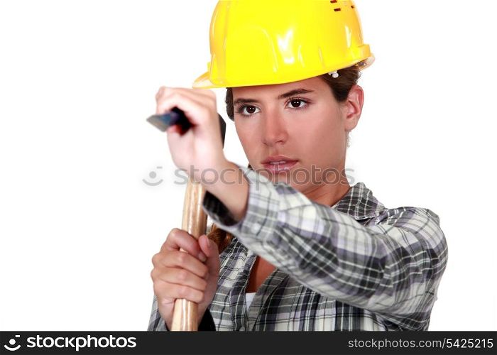Young woman using a hammer