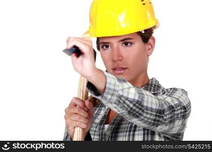 Young woman using a hammer