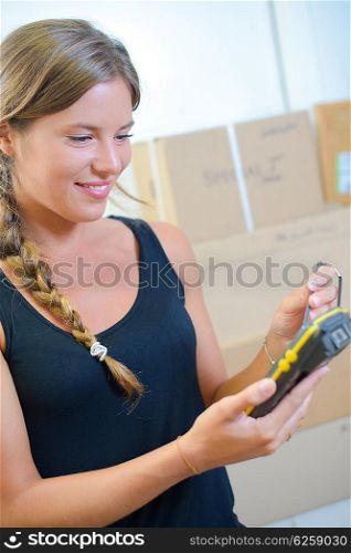 young woman using a hand-held inventory device