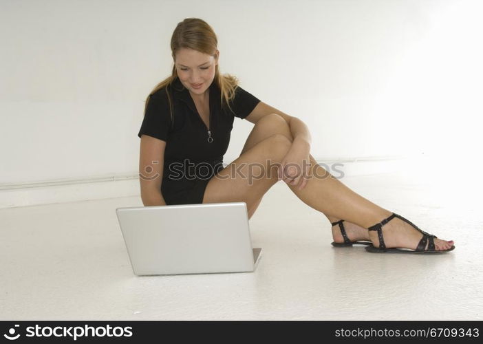 Young woman using a laptop and smiling