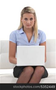 Young woman using a laptop on a sofa