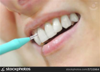 young woman using an interdental brush