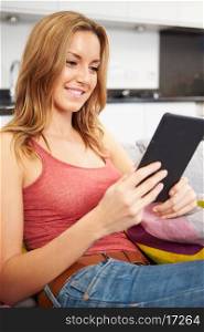 Young Woman Using Digital Tablet At Home