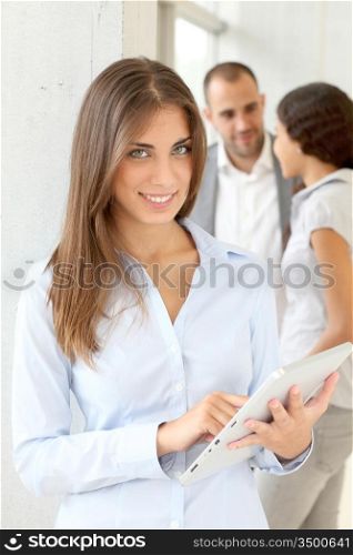 Young woman using electronic tablet in meeting