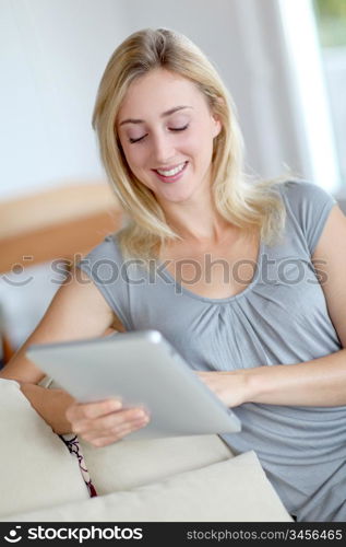 Young woman using electronic tablet in sofa