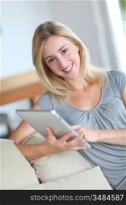 Young woman using electronic tablet in sofa