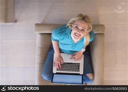 Young woman using her laptop computer in her luxury modern home top view