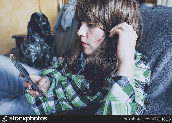 Young woman using her smartphone at home