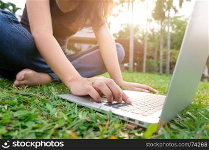 young woman using laptop at a outdoors