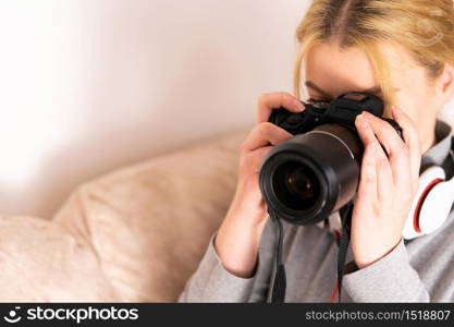 Young woman using mirrorless dslr camera on summer holiday taking pictures on the vacation at the hotel hall room tourist