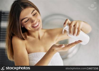 young woman using some skin lotion 2
