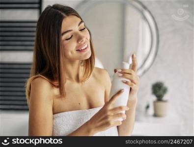 young woman using some skin lotion