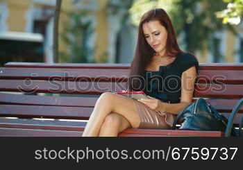 Young Woman Using Tablet Computer Outdoors