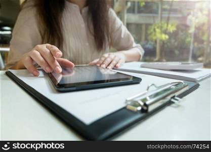 Young woman using tablet while working