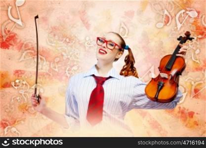 Young woman violinist. Image of young funny woman with violin against color background