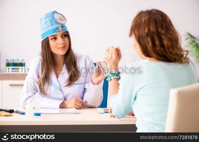 Young woman visiting female doctor otolaryngologist