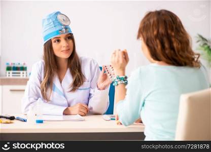 Young woman visiting female doctor otolaryngologist
