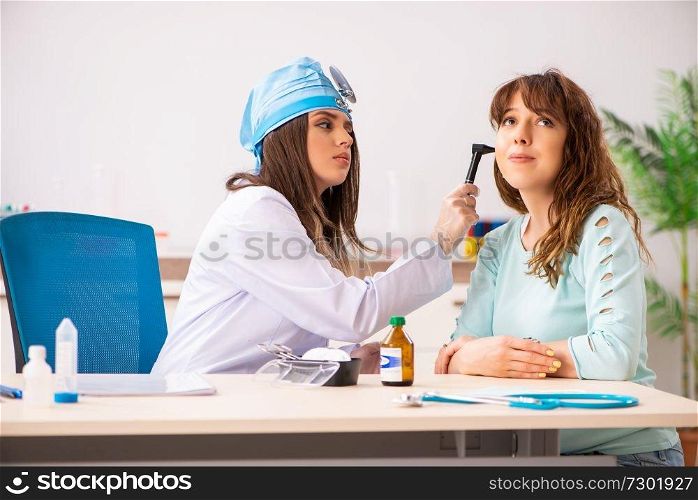 Young woman visiting female doctor otolaryngologist