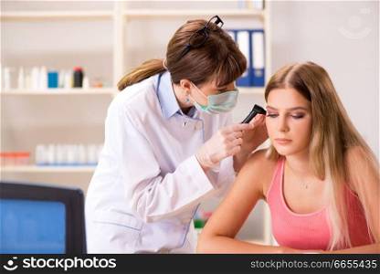 Young woman visiting female doctor otorhinolaryngologist 