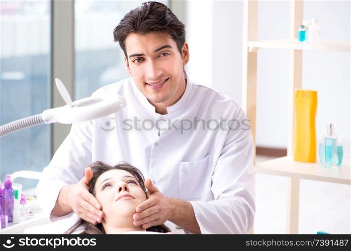 Young woman visiting male doctor cosmetologist . Young woman visiting male doctor cosmetologist