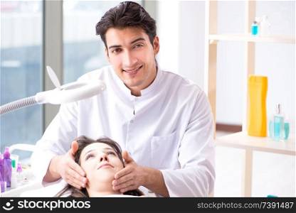 Young woman visiting male doctor cosmetologist . Young woman visiting male doctor cosmetologist