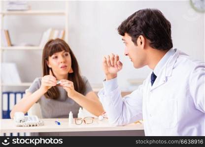 Young woman visiting male doctor ophthalmologist in hospital. The young woman visiting male doctor ophthalmologist in hospital