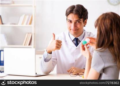 Young woman visiting male doctor ophthalmologist in hospital
