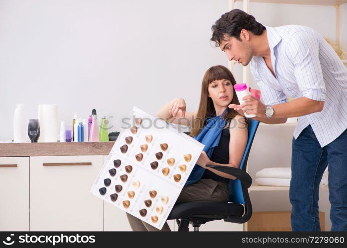 Young woman visiting young handsome barber 