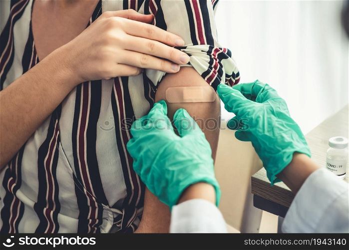 Young woman visits skillful doctor at hospital for vaccination . Covid 19 and coronavirus vaccination center service concept .. Young woman visits skillful doctor at hospital for vaccination