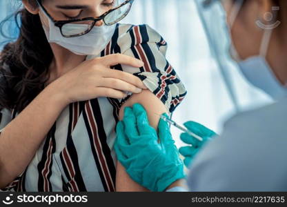 Young woman visits skillful doctor at hospital for vaccination . Covid 19 and coronavirus vaccination center service concept .. Young woman visits skillful doctor at hospital for vaccination